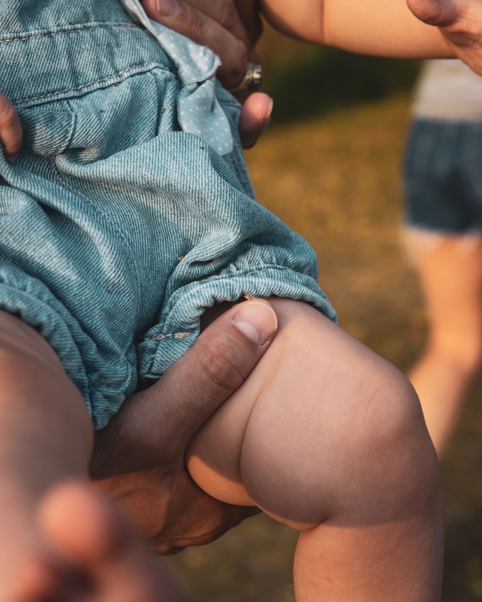 La main d'un parent sur la jambe du bébé